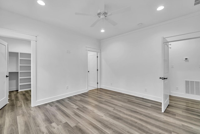 2672 Chat Holley Rd, Santa Rosa Beach, FL 32459 - unfurnished bedroom featuring wood finished floors, a walk in closet, recessed lighting, and ceiling fan