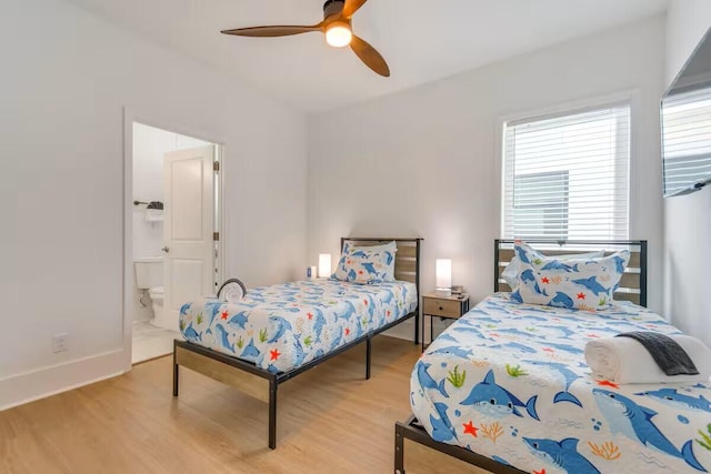 7411 Grand Navarre Blvd, Navarre, FL 32566 - bedroom with wood finished floors, a ceiling fan, and connected bathroom