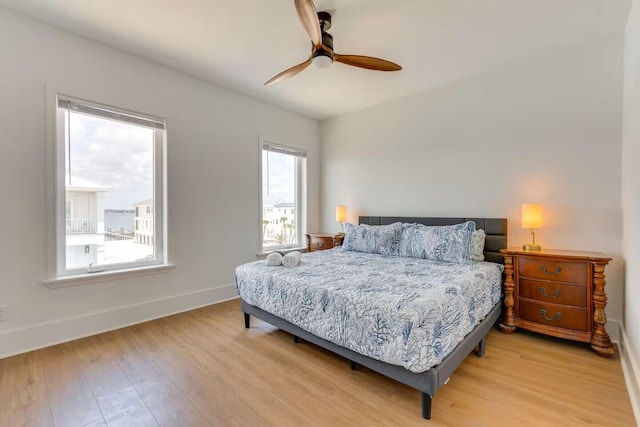 7411 Grand Navarre Blvd, Navarre, FL 32566 - bedroom featuring light wood finished floors and ceiling fan