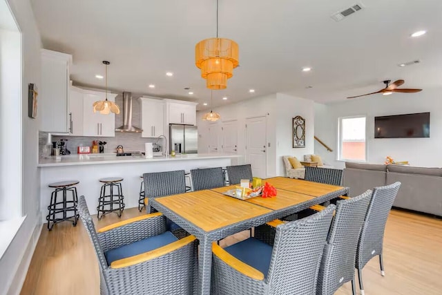 7411 Grand Navarre Blvd, Navarre, FL 32566 - dining space featuring light wood-style floors, a ceiling fan, and recessed lighting