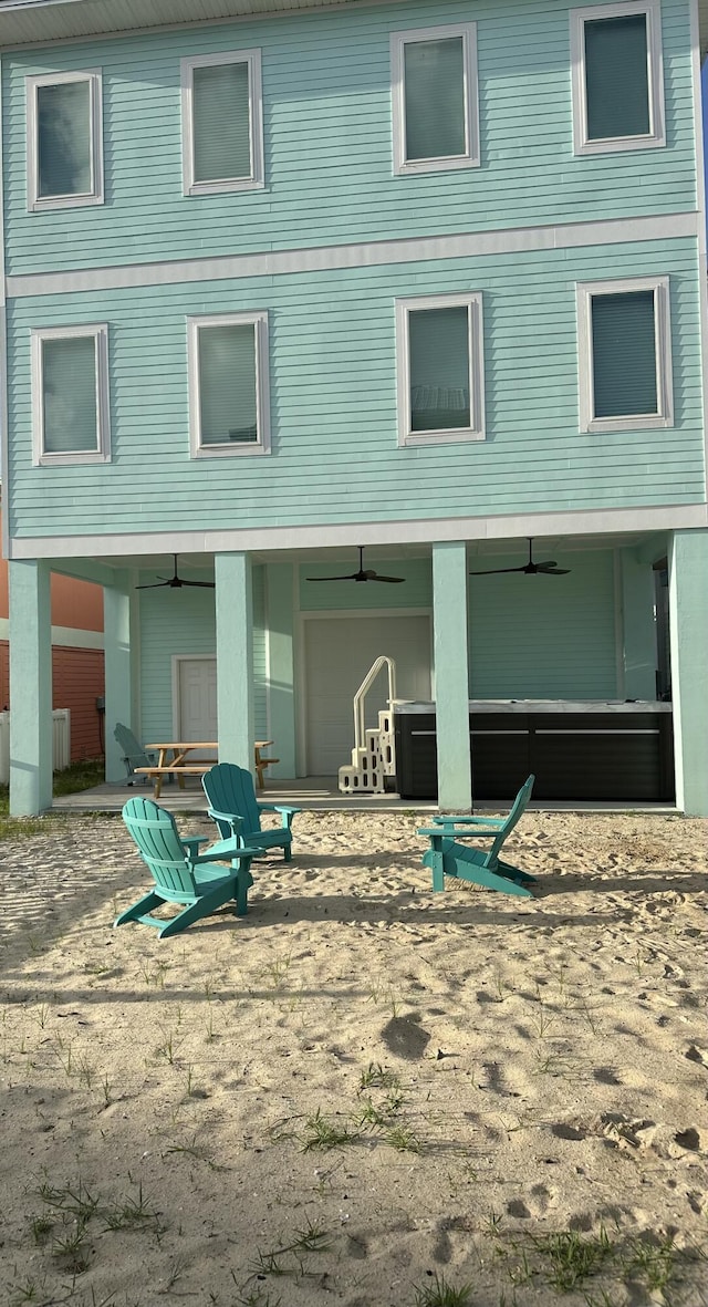 7411 Grand Navarre Blvd, Navarre, FL 32566 - back of property with ceiling fan and a patio area