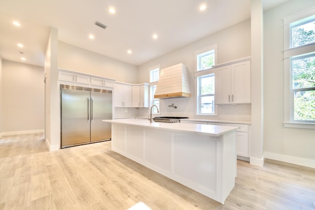 116 E Georgie Pt, Washington, FL 32459 - kitchen featuring stainless steel built in fridge, premium range hood, light countertops, light wood-style floors, and recessed lighting