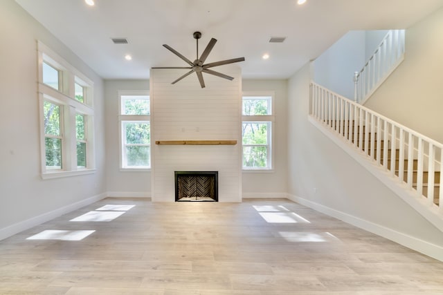 116 E Georgie Pt, Washington, FL 32459 - unfurnished living room with stairway, a large fireplace, ceiling fan, wood finished floors, and recessed lighting