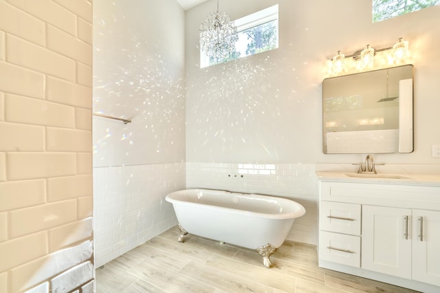 116 E Georgie Pt, Washington, FL 32459 - bathroom featuring a freestanding bath, tile walls, healthy amount of natural light, vanity, and wainscoting
