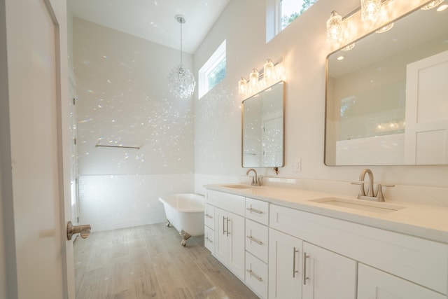 116 E Georgie Pt, Washington, FL 32459 - full bath with double vanity, a soaking tub, and wood finished floors