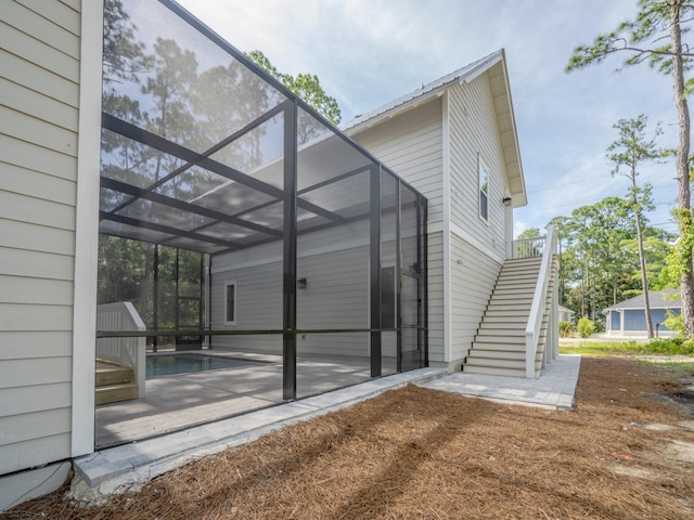 116 E Georgie Pt, Washington, FL 32459 - back of house featuring stairway, a patio area, an outdoor pool, and a lanai