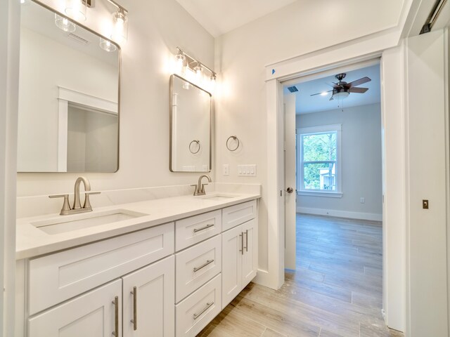 116 E Georgie Pt, Washington, FL 32459 - bathroom with double vanity, ceiling fan, and wood finished floors