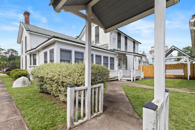 273 E Live Oak Ave, Defuniak Springs, FL 32435 - view of side of property with a metal roof