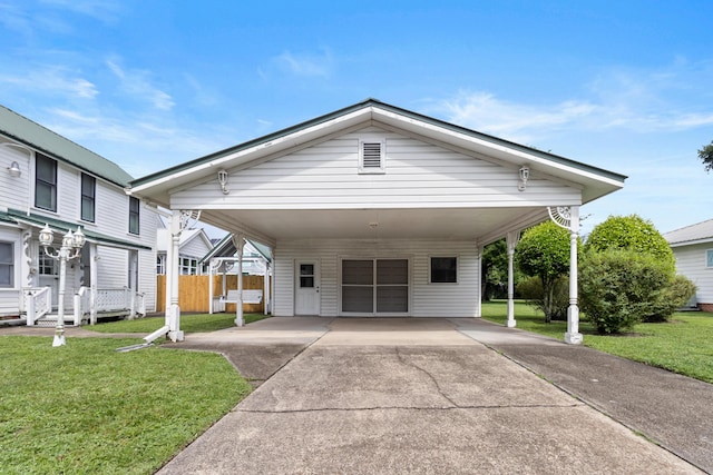 273 E Live Oak Ave, Defuniak Springs, FL 32435 - view of front facade featuring concrete driveway and an attached carport