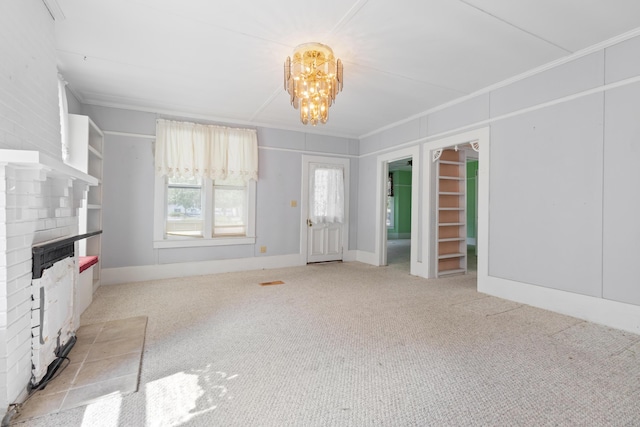 273 E Live Oak Ave, Defuniak Springs, FL 32435 - unfurnished living room with crown molding, a brick fireplace, carpet floors, and a chandelier