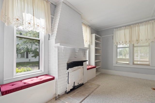 273 E Live Oak Ave, Defuniak Springs, FL 32435 - unfurnished living room featuring a large fireplace, plenty of natural light, and light carpet