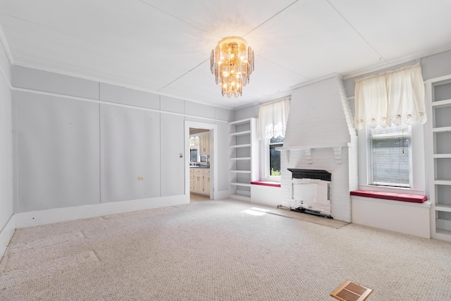 273 E Live Oak Ave, Defuniak Springs, FL 32435 - unfurnished living room featuring a fireplace, carpet, and a chandelier