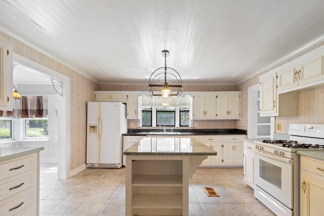 273 E Live Oak Ave, Defuniak Springs, FL 32435 - kitchen featuring white appliances, plenty of natural light, a center island, light tile patterned floors, and crown molding