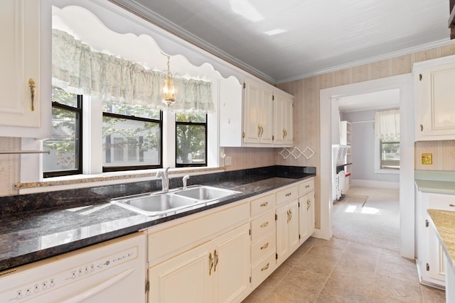 273 E Live Oak Ave, Defuniak Springs, FL 32435 - kitchen featuring white dishwasher, ornamental molding, healthy amount of natural light, dark countertops, and light tile patterned flooring
