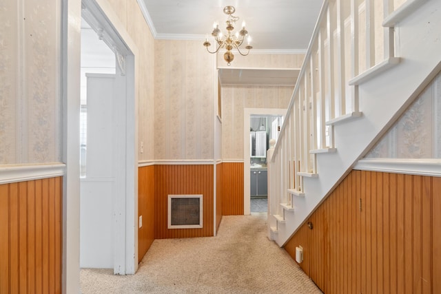 273 E Live Oak Ave, Defuniak Springs, FL 32435 - hallway featuring wainscoting, stairway, a chandelier, wallpapered walls, and carpet
