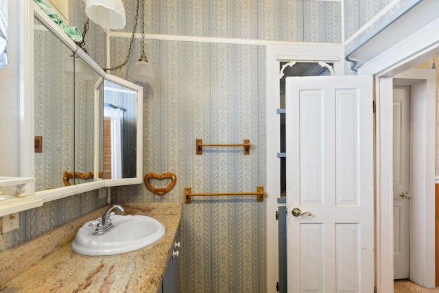 273 E Live Oak Ave, Defuniak Springs, FL 32435 - bathroom featuring wallpapered walls and vanity