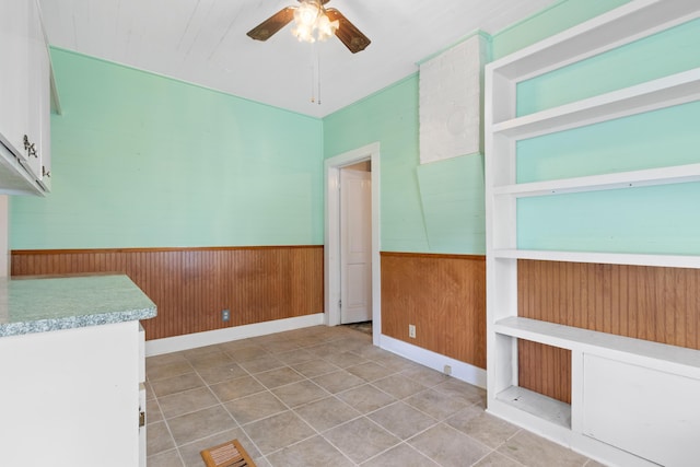 273 E Live Oak Ave, Defuniak Springs, FL 32435 - unfurnished room with ceiling fan, wood walls, and a wainscoted wall