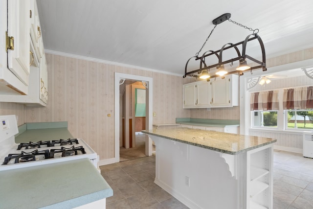 273 E Live Oak Ave, Defuniak Springs, FL 32435 - kitchen featuring white cabinetry, white range with gas stovetop, wallpapered walls, a center island, and open shelves