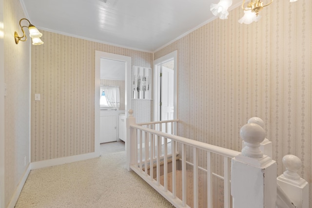 273 E Live Oak Ave, Defuniak Springs, FL 32435 - hallway with crown molding, an upstairs landing, a chandelier, and carpet