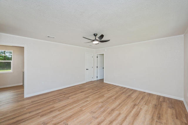 3375 Mclain Dr, Crestview, FL 32539 - unfurnished room with light wood-style floors, crown molding, a ceiling fan, and a textured ceiling