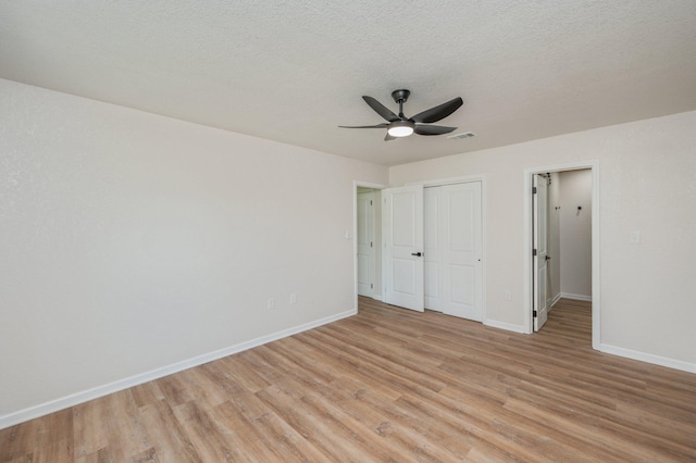 3375 Mclain Dr, Crestview, FL 32539 - unfurnished bedroom featuring light wood-type flooring, a closet, ceiling fan, and a textured ceiling