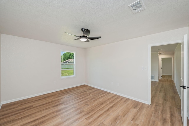 3375 Mclain Dr, Crestview, FL 32539 - empty room featuring light wood-style flooring, a ceiling fan, and a textured ceiling