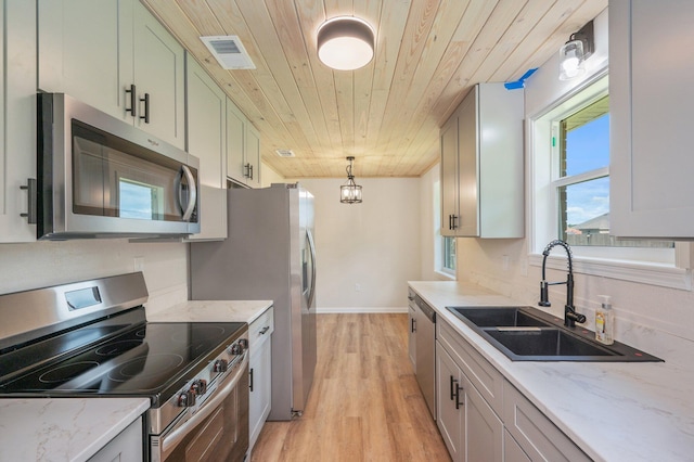 3375 Mclain Dr, Crestview, FL 32539 - kitchen with stainless steel appliances, wooden ceiling, light wood finished floors, hanging light fixtures, and light stone counters