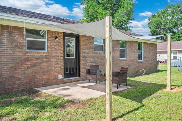 3375 Mclain Dr, Crestview, FL 32539 - back of property with a lawn, a patio area, and brick siding