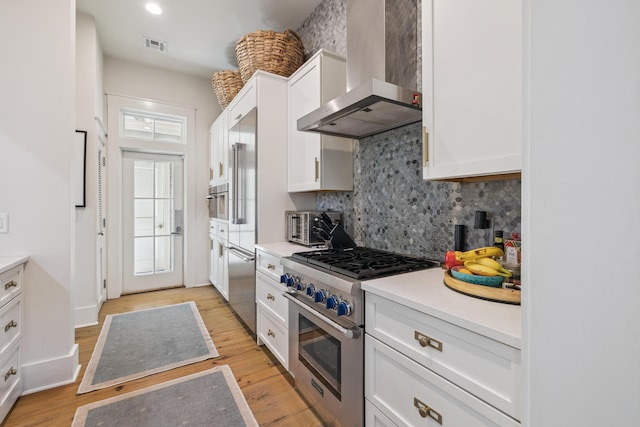 58 Pine Needle Way, Santa Rosa Beach, FL 32459 - kitchen with wall chimney range hood, stainless steel range, tasteful backsplash, and white cabinets