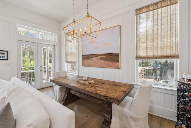58 Pine Needle Way, Santa Rosa Beach, FL 32459 - dining room featuring wood finished floors, a decorative wall, a chandelier, and french doors