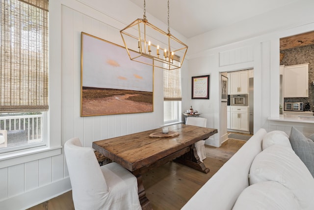 58 Pine Needle Way, Santa Rosa Beach, FL 32459 - dining space with wood finished floors, plenty of natural light, a chandelier, and a decorative wall