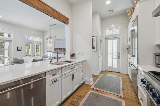 58 Pine Needle Way, Santa Rosa Beach, FL 32459 - kitchen featuring stainless steel dishwasher, cooktop, light countertops, recessed lighting, and white cabinets