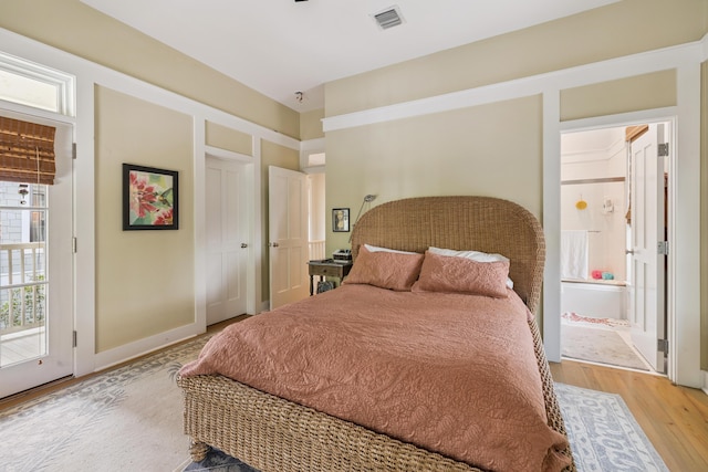 58 Pine Needle Way, Santa Rosa Beach, FL 32459 - bedroom with light wood finished floors and ensuite bath