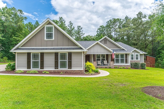2580 Taylor Rd, Crestview, FL 32536 - craftsman house with board and batten siding, a front lawn, brick siding, and a porch