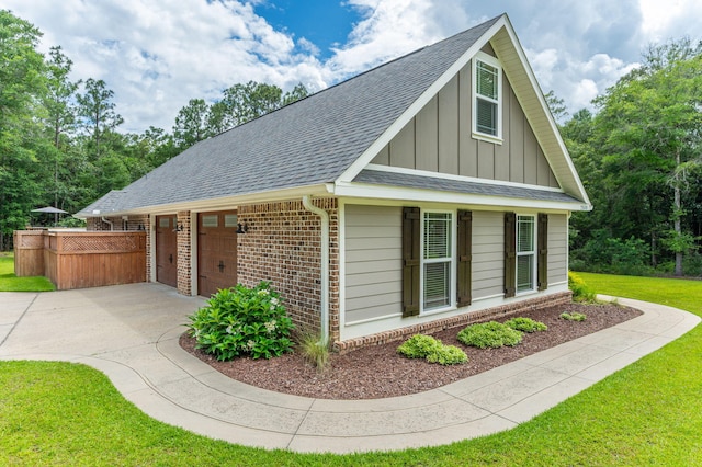 2580 Taylor Rd, Crestview, FL 32536 - view of front of property featuring concrete driveway, board and batten siding, roof with shingles, brick siding, and a front lawn