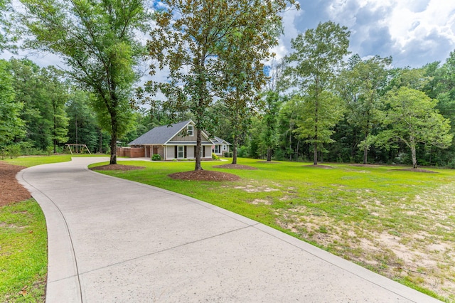 2580 Taylor Rd, Crestview, FL 32536 - view of front of house featuring driveway, a front yard, and a view of trees