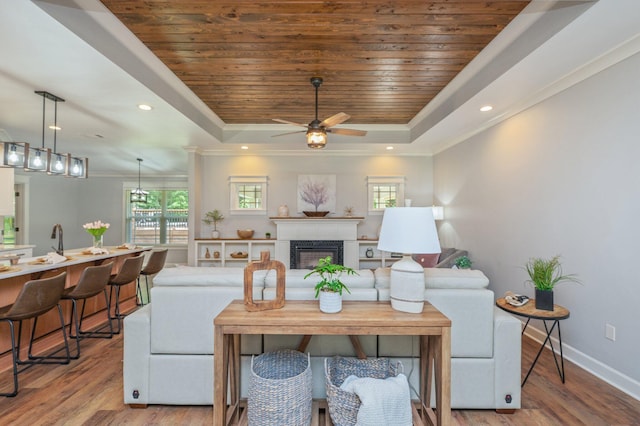 2580 Taylor Rd, Crestview, FL 32536 - living area featuring a raised ceiling, plenty of natural light, wood finished floors, wooden ceiling, and crown molding
