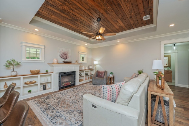 2580 Taylor Rd, Crestview, FL 32536 - living room with a raised ceiling, wood ceiling, wood finished floors, a ceiling fan, and a tiled fireplace