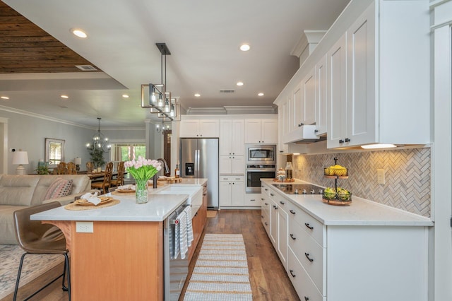 2580 Taylor Rd, Crestview, FL 32536 - kitchen with stainless steel appliances, open floor plan, ornamental molding, wood finished floors, and white cabinets