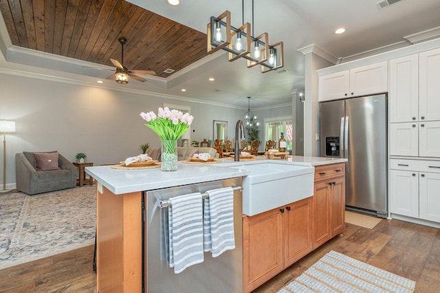 2580 Taylor Rd, Crestview, FL 32536 - kitchen featuring appliances with stainless steel finishes, a center island with sink, ornamental molding, a raised ceiling, and open floor plan