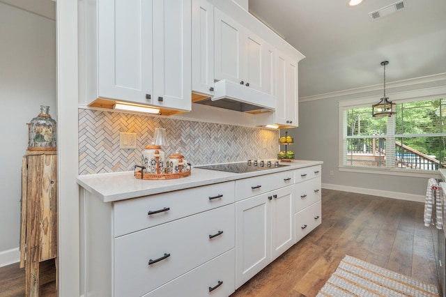 2580 Taylor Rd, Crestview, FL 32536 - kitchen with black electric cooktop, backsplash, under cabinet range hood, light countertops, and white cabinets