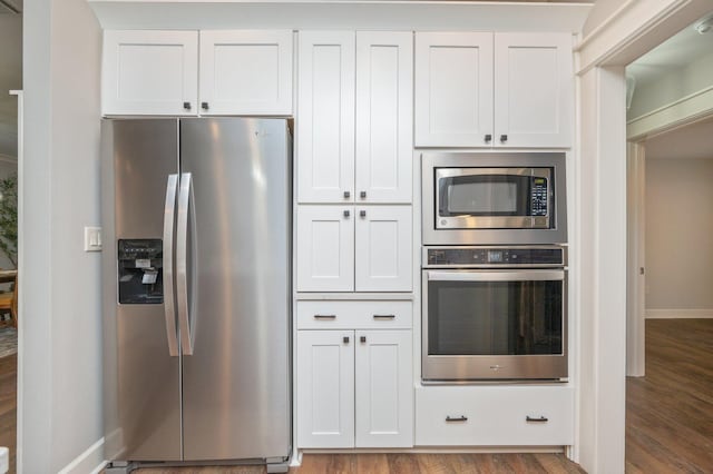 2580 Taylor Rd, Crestview, FL 32536 - kitchen with stainless steel appliances, wood finished floors, and white cabinetry