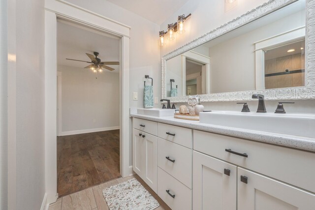 2580 Taylor Rd, Crestview, FL 32536 - bathroom featuring double vanity, a ceiling fan, and wood finished floors