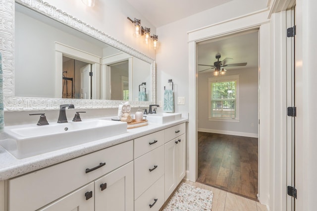 2580 Taylor Rd, Crestview, FL 32536 - bathroom featuring double vanity, a ceiling fan, and wood finished floors
