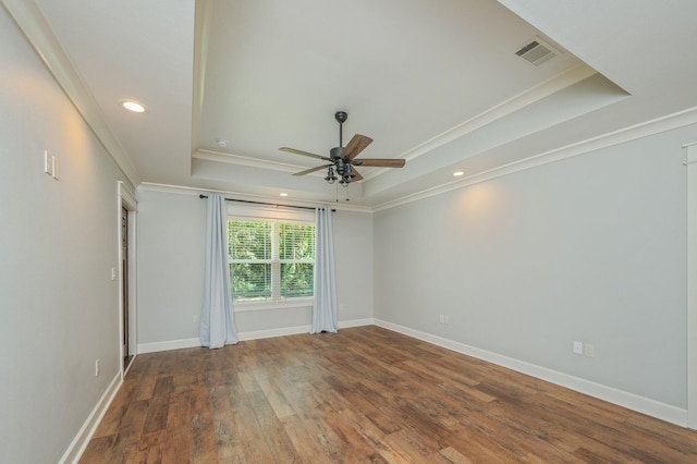 2580 Taylor Rd, Crestview, FL 32536 - empty room with a raised ceiling, a ceiling fan, crown molding, wood finished floors, and recessed lighting
