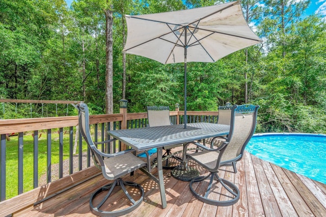 2580 Taylor Rd, Crestview, FL 32536 - wooden terrace featuring outdoor dining space, an outdoor pool, and a lawn