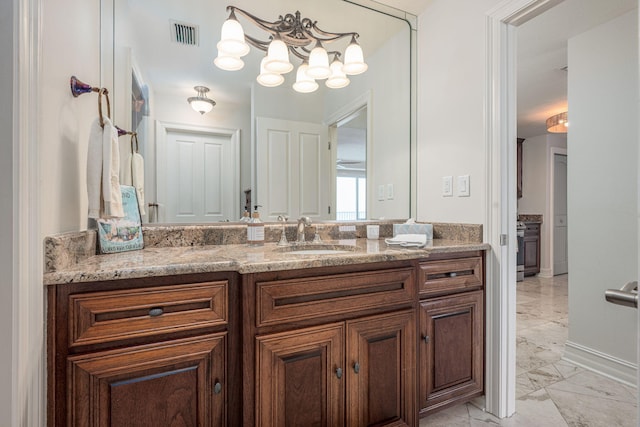 955 Scenic Gulf Dr Unit 350, Miramar Beach, FL 32550 - bathroom featuring marble look tiles, vanity, and a chandelier