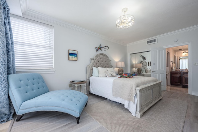 955 Scenic Gulf Dr Unit 350, Miramar Beach, FL 32550 - bedroom featuring light wood-type flooring, crown molding, and a chandelier
