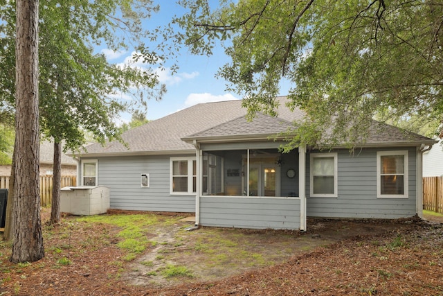 419 Symphony Way, Freeport, FL 32439 - rear view of house featuring roof with shingles and a sunroom