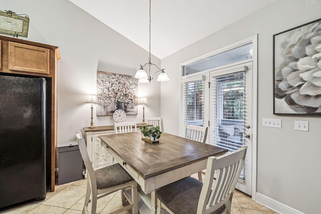 419 Symphony Way, Freeport, FL 32439 - dining room featuring lofted ceiling, light tile patterned flooring, and a chandelier